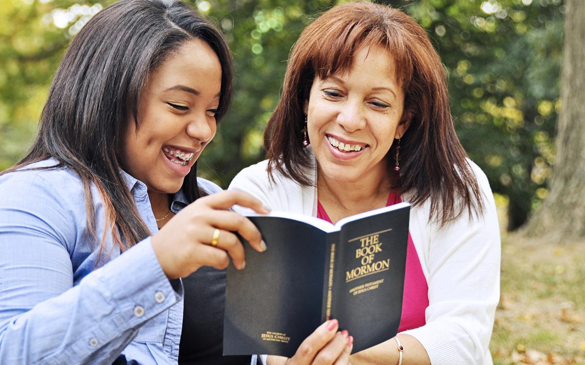 Mother reading scriptures with daughter