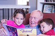 Grandpa reading the Friend with children