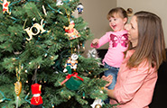 Girl and mother looking at a Christmas tree