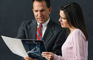 man and woman looking at book