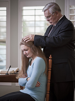 young woman receiving blessing