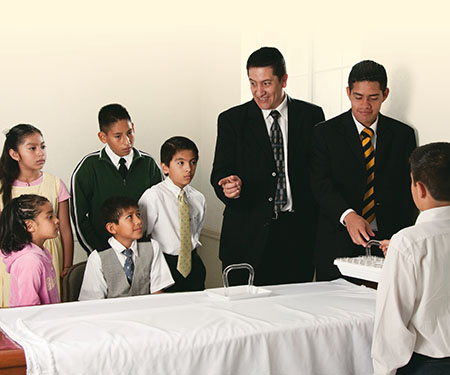 Primary class gathered at the sacrament table