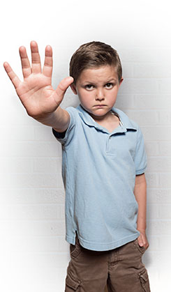 boy with right hand raised in front of him