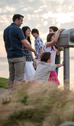family looking out telescope