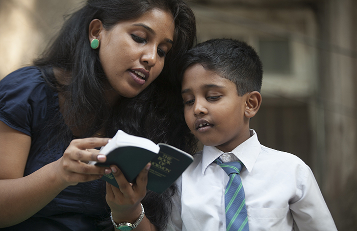 mother reading scriptures to son