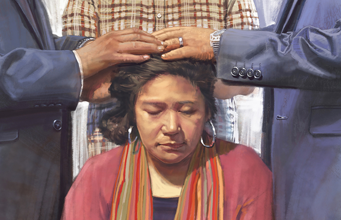 woman receiving priesthood blessing
