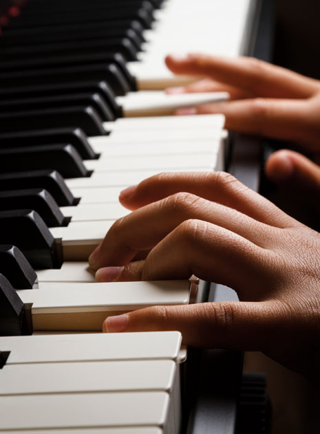 fingers on a piano keyboard