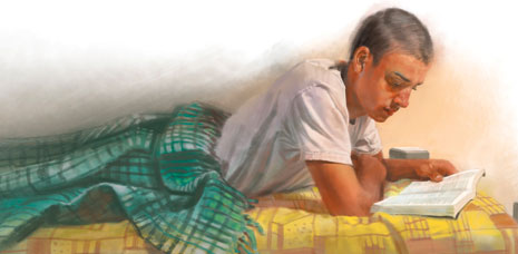 young man reading in bed